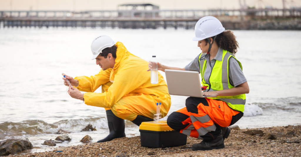 Two environmental engineers testing water