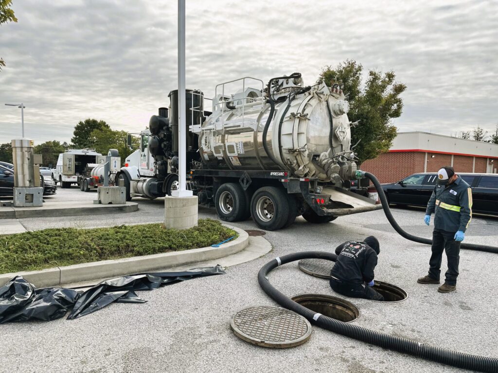 Vacuum truck service being performed