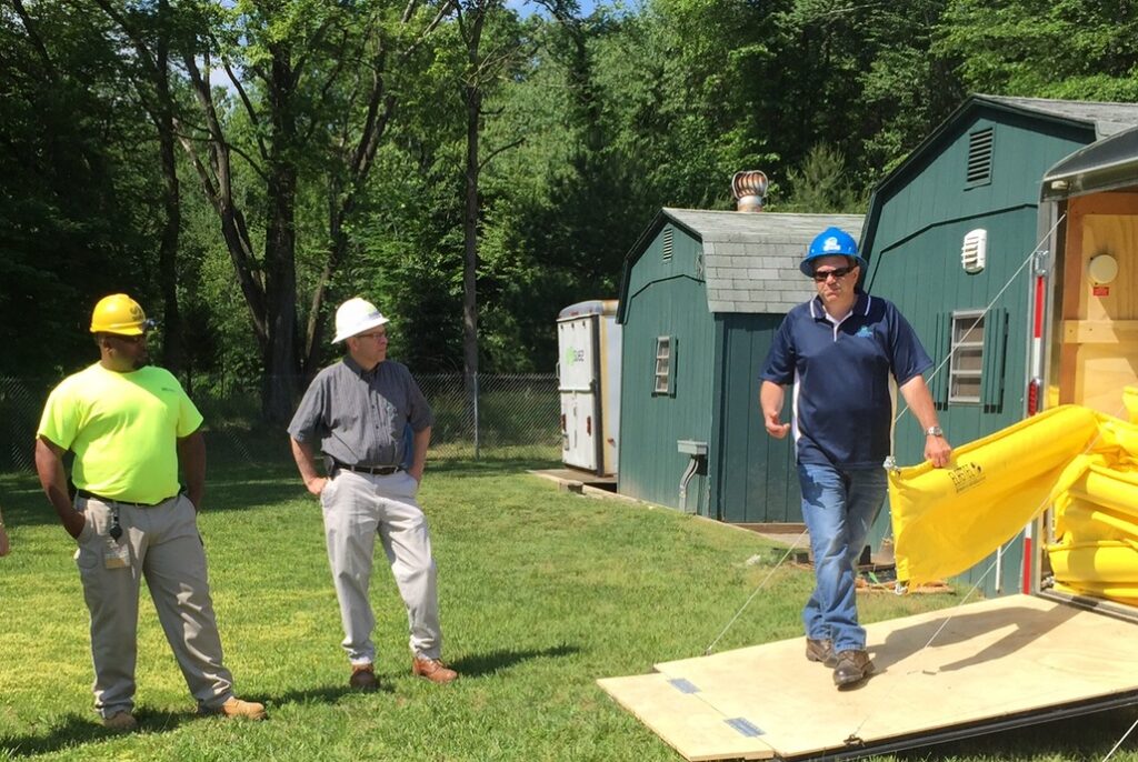 Miller Environmental Group team members walking across a lawn